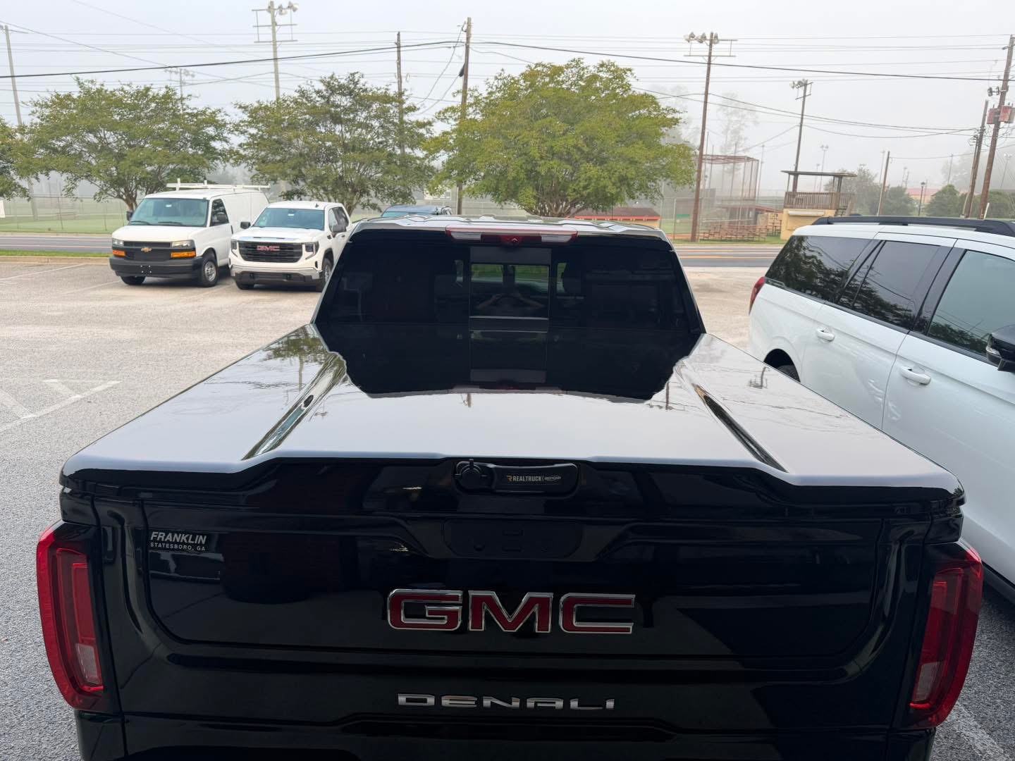 Rear view of a GMC Denali with a low-profile hard tonneau cover