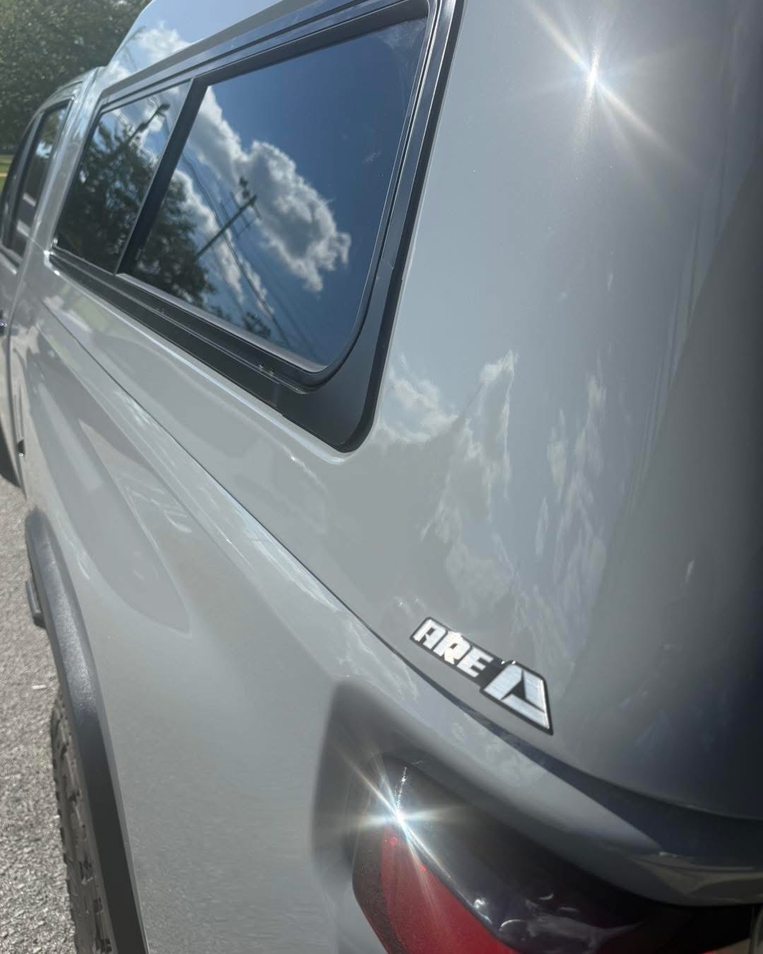 Close-up of a truck cap side window and exterior trim