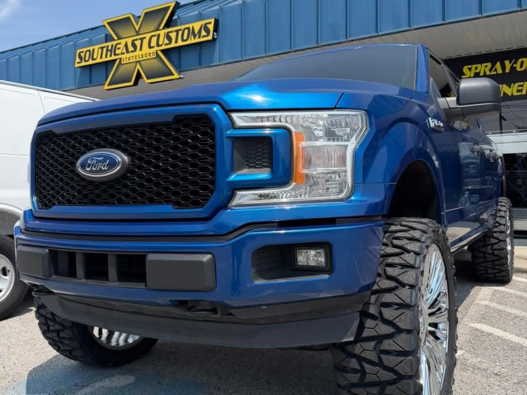 Blue lifted pickup with off-road tires